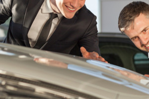 Two elegant handsome men admiring new luxurious shiny car